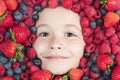 Healthy food for kids. Mix of berries. Kids face with fresh berries fruits. Assorted mix of berries strawberry Royalty Free Stock Photo