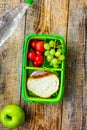 healthy food in lunchbox for dinner at school wooden table backg Royalty Free Stock Photo