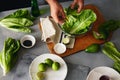 Healthy food man preparing green detox salad romaine lettuce