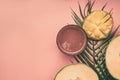 Healthy food, melon, mango smoothies lined on a tropical leaf, on a pink background, space for text flat lay