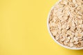 Healthy food. Muesli for breakfast. White bowl. Yellow background