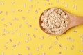 Healthy food. Muesli for breakfast. Yellow background. Wooden spoon