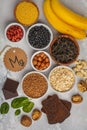 Healthy food nutrition dieting concept. Assortment of high magnesium sources. Banana chocolate spinach, buckwheat, nuts, beans, o