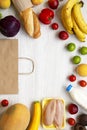 Healthy food and paper bag on white wooden table. Cooking food background. Flat lay of fresh foods. Top view, overhead, from above Royalty Free Stock Photo