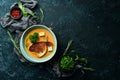 Healthy food. Pea cream soup with toast in a plate on a black stone background. Top view. Rustic style Royalty Free Stock Photo