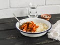 Healthy food - pumpkin stew and couscous in a white enamel bowl on a dark wooden Board. A vegetarian lunch. Royalty Free Stock Photo