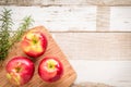 Healthy food: red apples and rosemary on wooden table Royalty Free Stock Photo