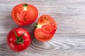 Red tomato cut in half close up on a wooden table Royalty Free Stock Photo