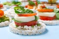 Healthy food rice cake sandwich on light blue background. Rice cookies sandwich on table with sandwiches on background Royalty Free Stock Photo