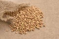 Healthy food. Scattered buckwheat grains. Brown background