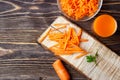 Healthy food - sliced carrot and carrots juice on wooden background