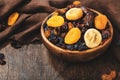 Healthy food snack: sun dried organic mix of dried fruits: apricots, figs, raisins, dates, and other on wooden table, top view Royalty Free Stock Photo