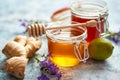 Healthy food table with different kinds of honey, fresh ginger and lime