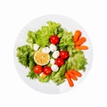 Healthy food. Tasty salad with cherry tomatoes, salad leaves, lemon, spices, carrot and quail eggs isolated on white background Royalty Free Stock Photo