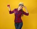 Happy modern woman farmer dancing with an apple