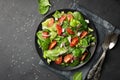 Healthy food. Top view of a fresh green vegetable salad of spinach, tomato, lettuce and sesame seeds