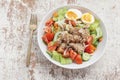 Healthy food tuna salad add egg in white bowl on wood background Royalty Free Stock Photo