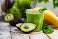 Healthy food and vegan diet concept - glass of fresh green juice or smoothie with kiwi, spinach, banana, avocado, apple. Royalty Free Stock Photo