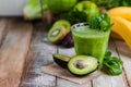 Healthy food and vegan diet concept - glass of fresh green juice or smoothie with kiwi, spinach, banana, avocado, apple. Royalty Free Stock Photo