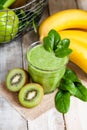 Healthy food and vegan diet concept - jar of fresh green juice or smoothie with kiwi, spinach, banana, apple. Antioxidant detox Royalty Free Stock Photo