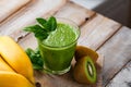 Healthy food and vegan diet concept - jar of fresh green juice or smoothie with kiwi, spinach, banana, apple. Antioxidant detox Royalty Free Stock Photo