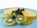 Healthy food. Vitamin bomb. Lemon kiwi chokeberry and blueberry on a plate. Lots of vitamins and antioxidants.