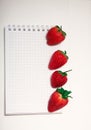 Healthy Food Vitamin Concept. Delicious strawberry on board on white background with empty paper notebook. Royalty Free Stock Photo