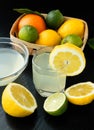 Healthy food and vitamins: fresh lemon and lime orange with leaves and freshly squeezed delicious juice in a glass bowl on Royalty Free Stock Photo