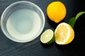 Healthy food and vitamins: fresh lemon and lime orange with leaves and freshly squeezed delicious juice in a glass bowl on Royalty Free Stock Photo