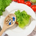 Healthy food vs pills. Salmon, vegetables and fruis vs medicine and drugs Royalty Free Stock Photo