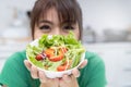 Healthy food for wellbeing. happy women eating mixed vegetables fresh salad as dinner at home Royalty Free Stock Photo