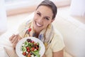 Healthy food, woman in portrait with salad and diet, organic vegetables and relax on sofa with smile for weight loss Royalty Free Stock Photo