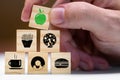 Healthy food, wooden blocks with different symbols of fast food, above an apple in green