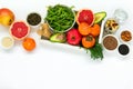 Healthy food in wooden tray: fruits, vegetables, seeds and greens on white background Royalty Free Stock Photo