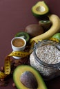 Healthy food and yellow tape measure over brown table. Fitness and health concept. Royalty Free Stock Photo