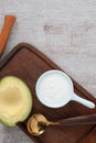 Healthy food yoghurt in bowl has avocado fruit on white wood table Royalty Free Stock Photo