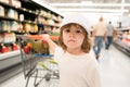 Healthy food for young family with kids. Boy at grocery store or supermarket. Portrait of funny little child holding Royalty Free Stock Photo