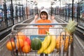 Healthy food for young family with kids. Boy at grocery store or supermarket. Portrait of funny little child holding Royalty Free Stock Photo