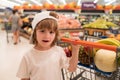 Healthy food for young family with kids. Boy at grocery store or supermarket. Portrait of funny little child holding Royalty Free Stock Photo