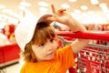 Healthy food for young family with kids. Portrait of funny little child holding shopping bag full of fresh vegetables. Royalty Free Stock Photo