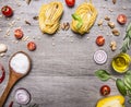 Healthy foods, cooking and vegetarian concept pasta with flour, vegetables, oil and herbs on wooden rustic background top view bor Royalty Free Stock Photo