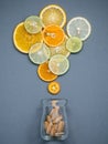 Healthy foods and medicine concept. Bottle of vitamin C and various citrus fruits. Citrus fruits sliced lime,orange and lemon on Royalty Free Stock Photo