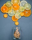 Healthy foods and medicine concept. Bottle of vitamin C and various citrus fruits. Mixed citrus fruits sliced Royalty Free Stock Photo