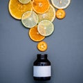 Healthy foods and medicine concept. Bottle of vitamin C and various citrus fruits. Mixed citrus fruits sliced lime,orange and Royalty Free Stock Photo