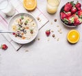 Healthy foods, vegetarian concept hazelnuts, strawberries and oranges, oatmeal, milk juice border ,place for text on wooden Royalty Free Stock Photo
