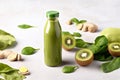 Healthy fresh detox spinach smoothie with green apple, kiwi and ginger in a bottles
