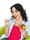 Healthy Fresh Faced Young Woman Smiling Eating a Fresh Fruit Salad