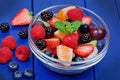 Healthy fresh fruit salad in a bowl on wooden table Royalty Free Stock Photo