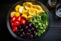 Healthy fresh fruit salad in glass bowl on wooden table with copy space for text, top down view Royalty Free Stock Photo