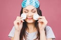 Healthy fresh girl removing makeup from her face with cotton pad. Beauty woman cleaning her face with cotton swab pad isolated on Royalty Free Stock Photo